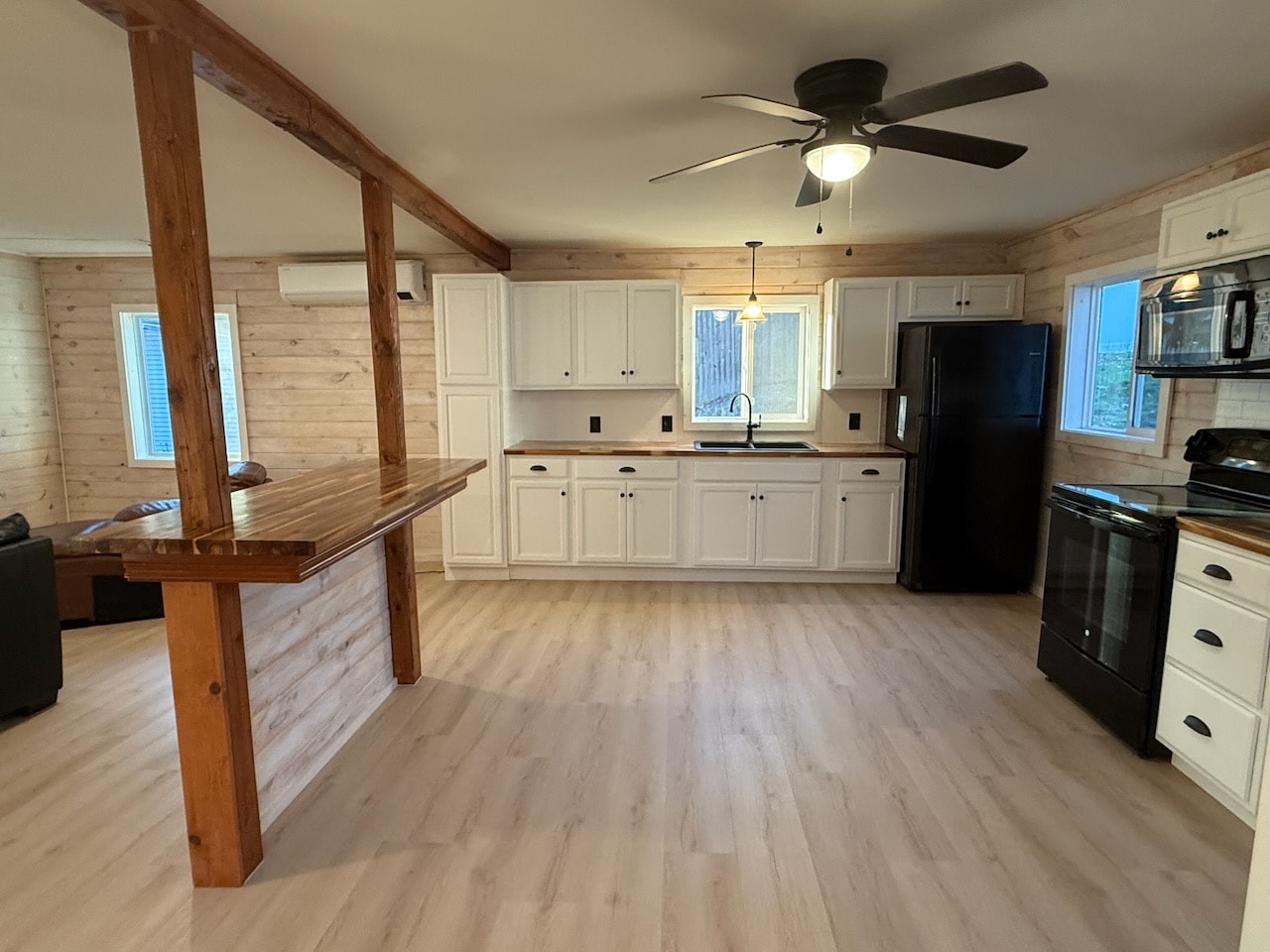 Custom kitchen renovation with wood beam ceiling and island by Maine General Contractors