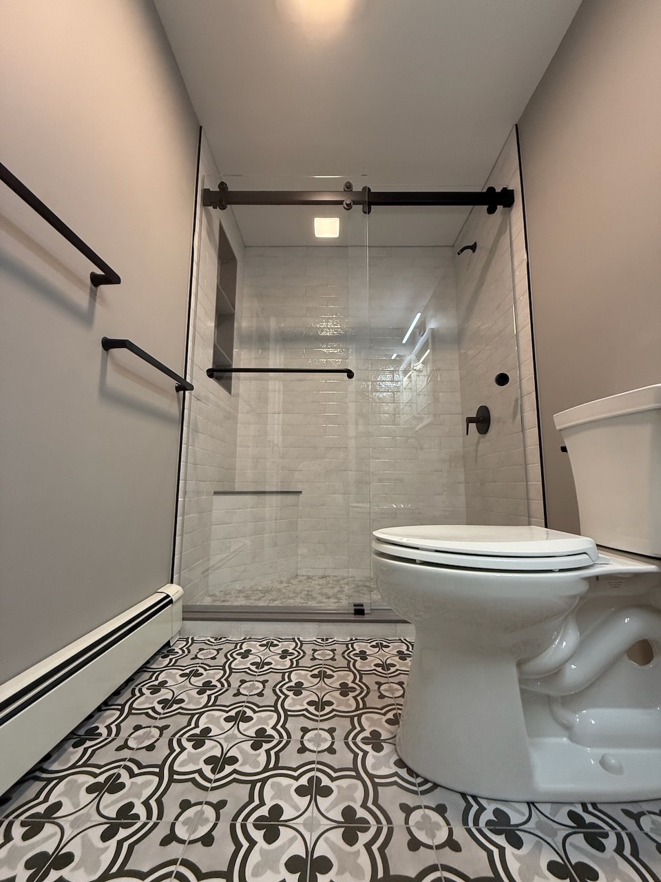 Modern bathroom renovation with glass shower enclosure by Maine General Contractors