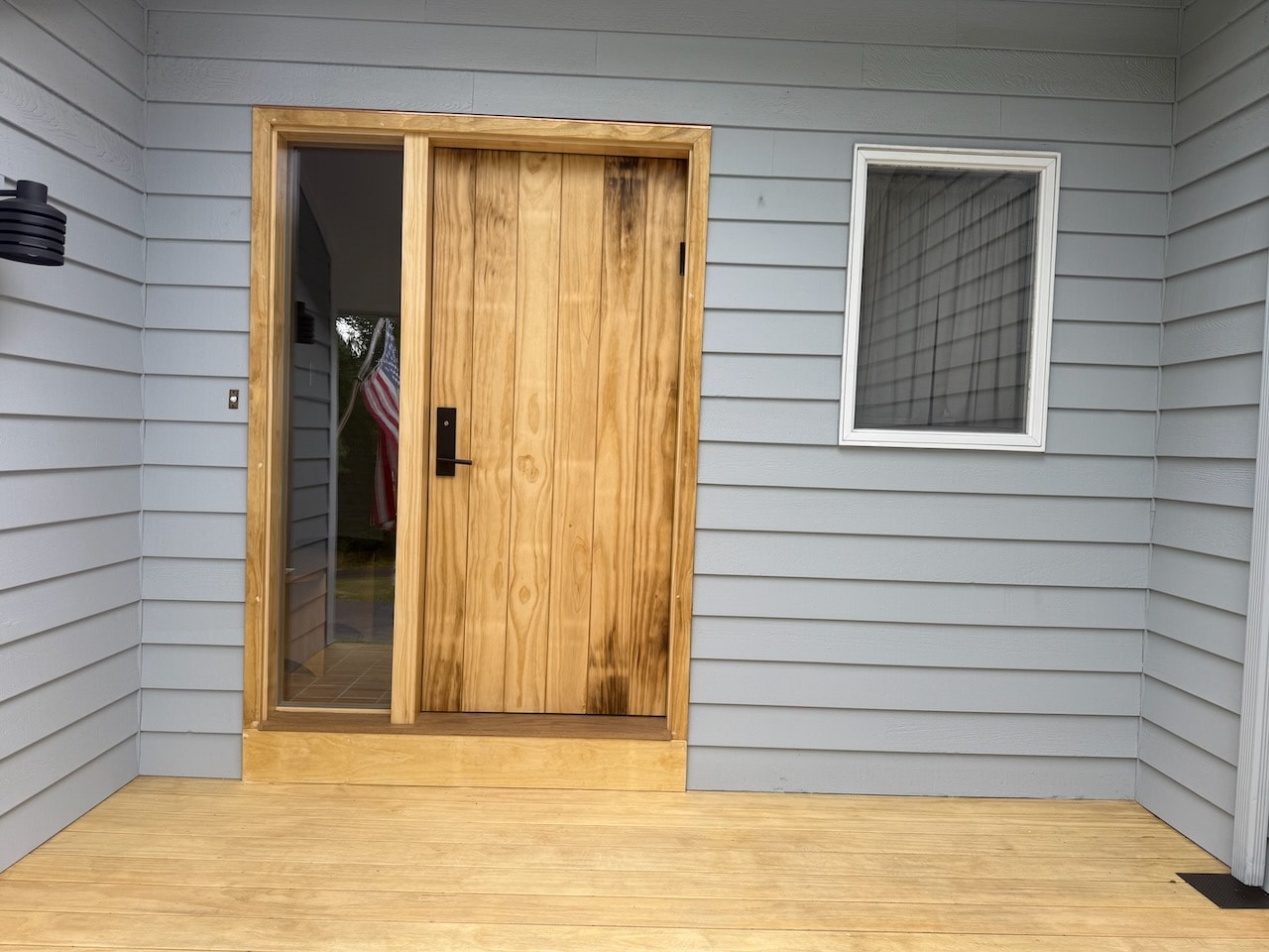 Modern entry addition with sliding glass doors and stone walkway by Maine General Contractors