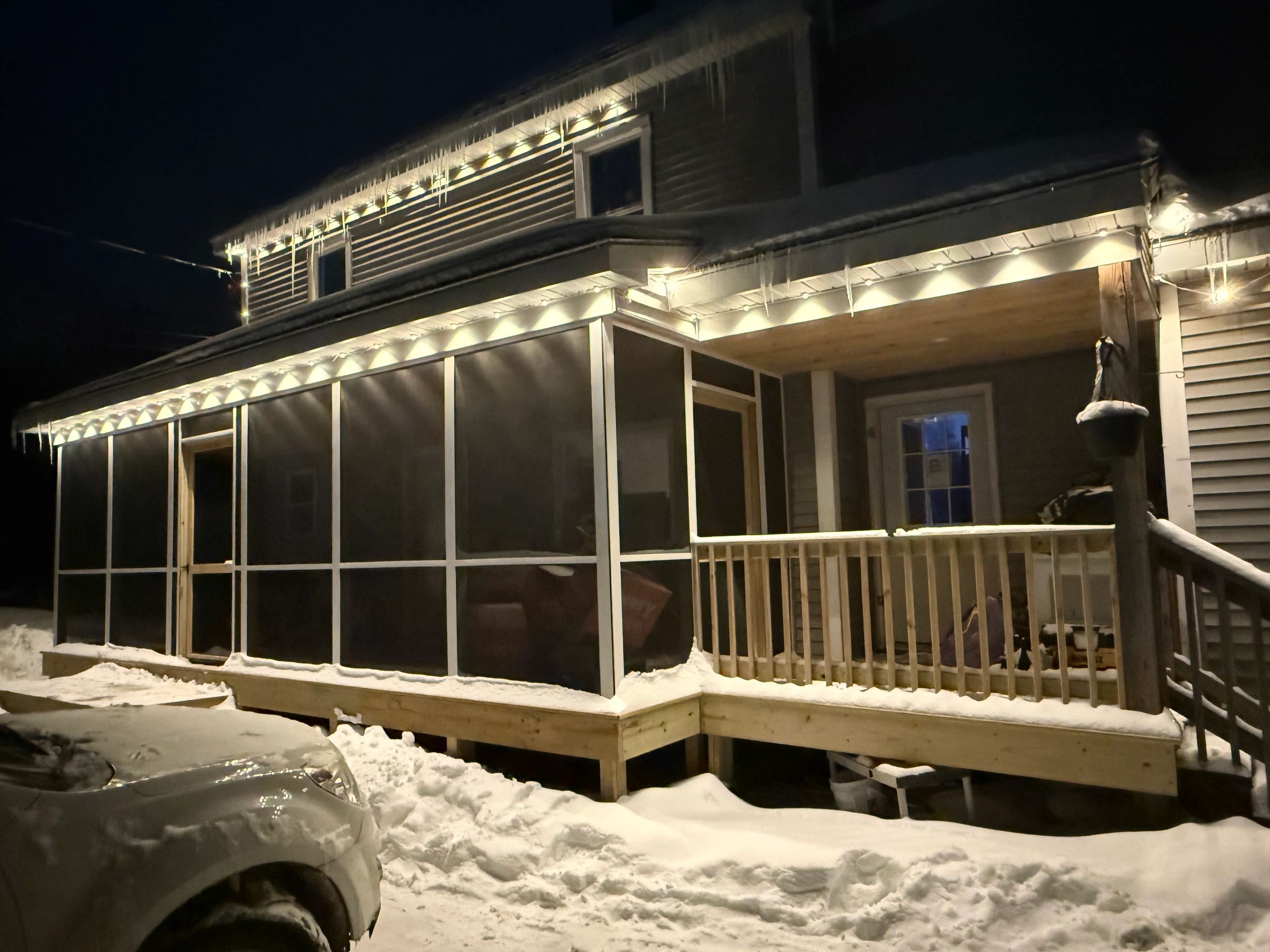 Finished residential home exterior with evening lighting